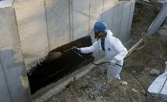 Professional waterproofing the exterior walls of the basement in Omaha, NE