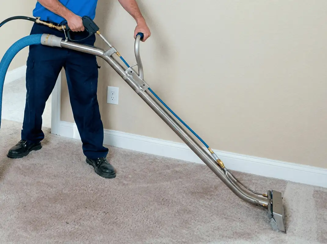 Professional operating a liquid removal machine on a carpeted floor in Omaha, NE